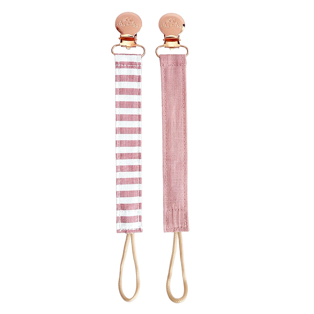 Ritzy Itzy Clip pink linen pacifier straps against white backdrop