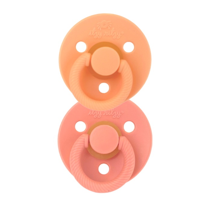 Itzy Ritzy apricot and terracotta itzy soother natural rubber pacifier set against white backdrop
