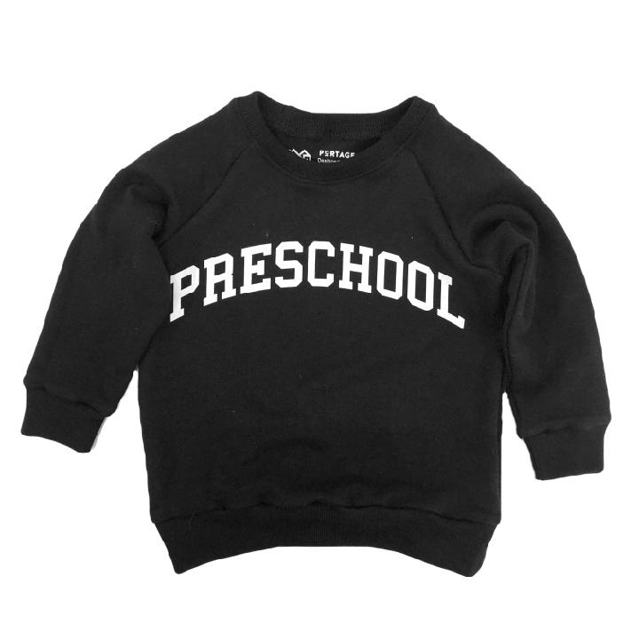 Portage and Main black preschool sweatshirt against white backdrop