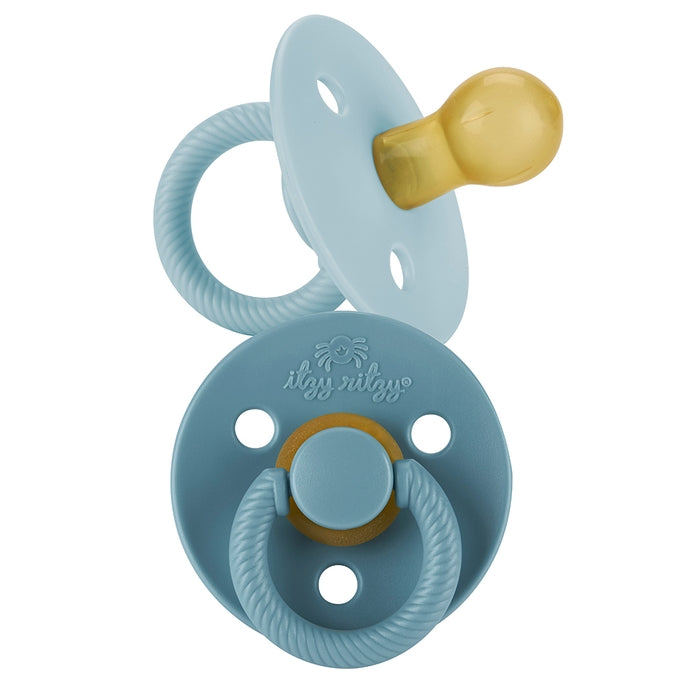 Itzy Ritzy blue itzy soother natural rubber pacifier set against white backdrop