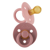 Itzy Ritzy Pink itzy soother natural rubber pacifier set against white backdrop
