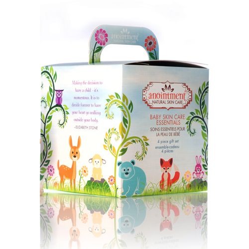 Gift box with handle featuring cartoon woodland animals containing 4 piece baby skin care essentials gift set by anointment natural skin care.