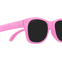 Roshambo Baby glitter pink sun glasses with black lens against white backdrop