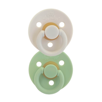Itzy Ritzy white natural and mint itzy soother natural rubber pacifier set against white backdrop