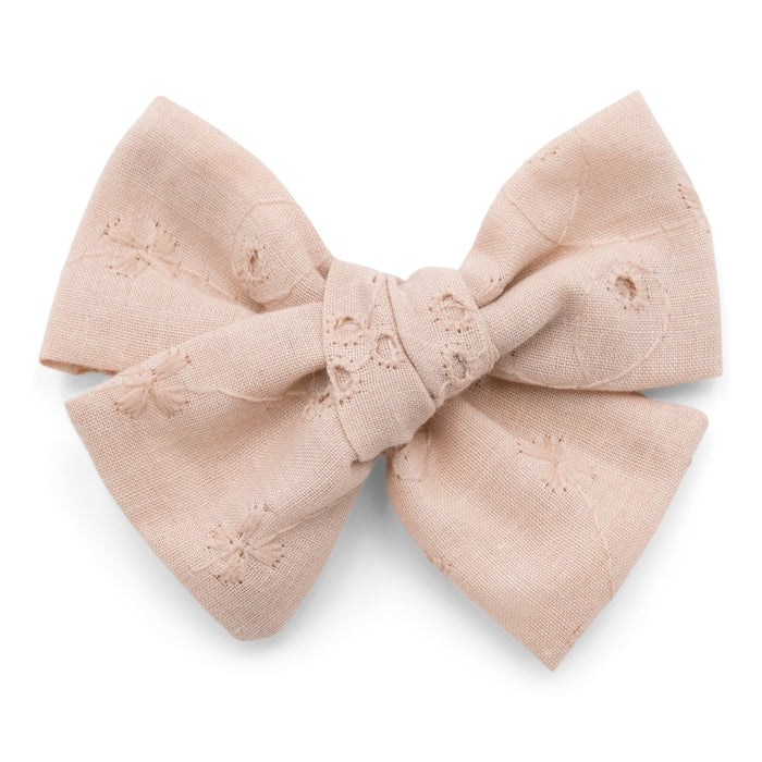 The Kindred Studio muted pink eyelet midi bow against white backdrop
