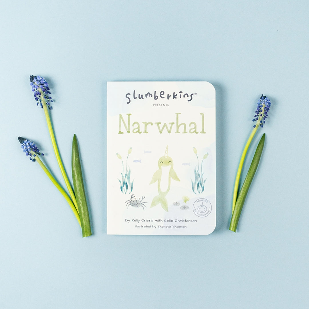 Slumberkins narwhal board book against blue backdrop