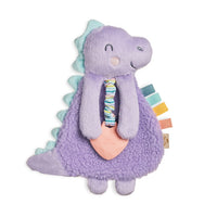 Itzy Ritzy purple dino plush with silicone teether against white backdrop