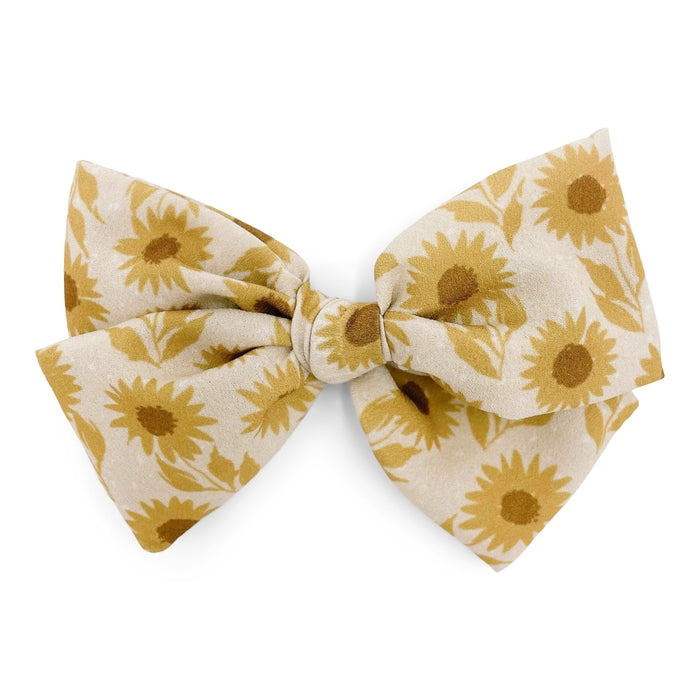 The Kindred Studio sunflowers midi bow against white backdrop