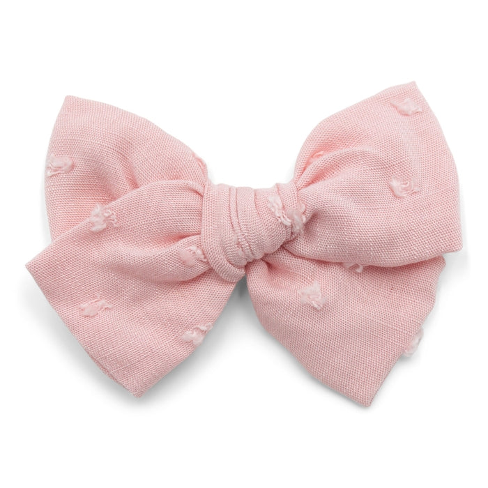 The Kindred Studio pink tuft midi bow against white backdrop