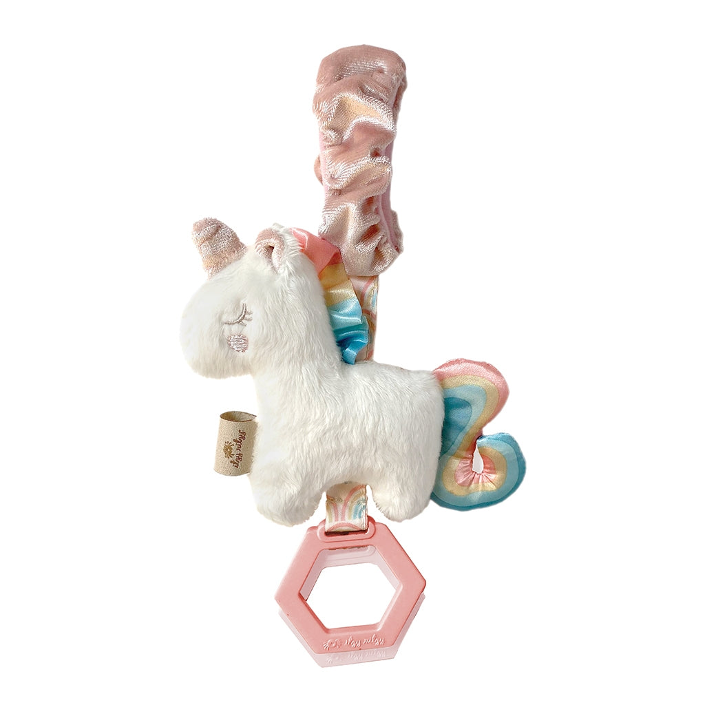 Itzy Ritzy unicorn ritzy jingle attachable travel toy against white backdrop