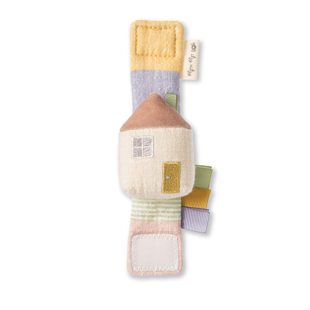 Itzy Ritzy cottage wrist rattle against white backdrop