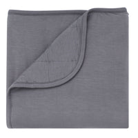 Kyte Baby charcoal baby blanket against white backdrop